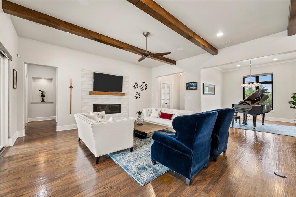 809 Legacy Trail Colleyville, TX 76034 - Photo 6 of 40 a living room with furniture a fireplace and a flat screen tv
