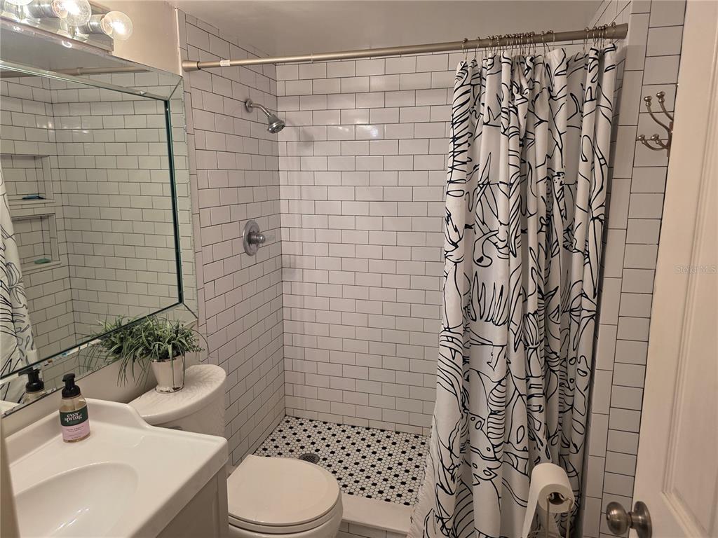 17580 Gulf Boulevard, Unit 311 Redington Shores, FL 33708 - Photo 20 of 34 a bathroom with a sink toilet and shower