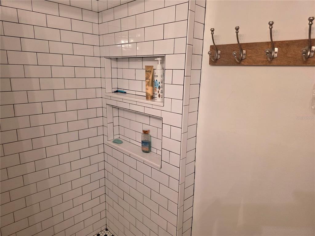 17580 Gulf Boulevard, Unit 311 Redington Shores, FL 33708 - Photo 21 of 34 a bathroom with a shower