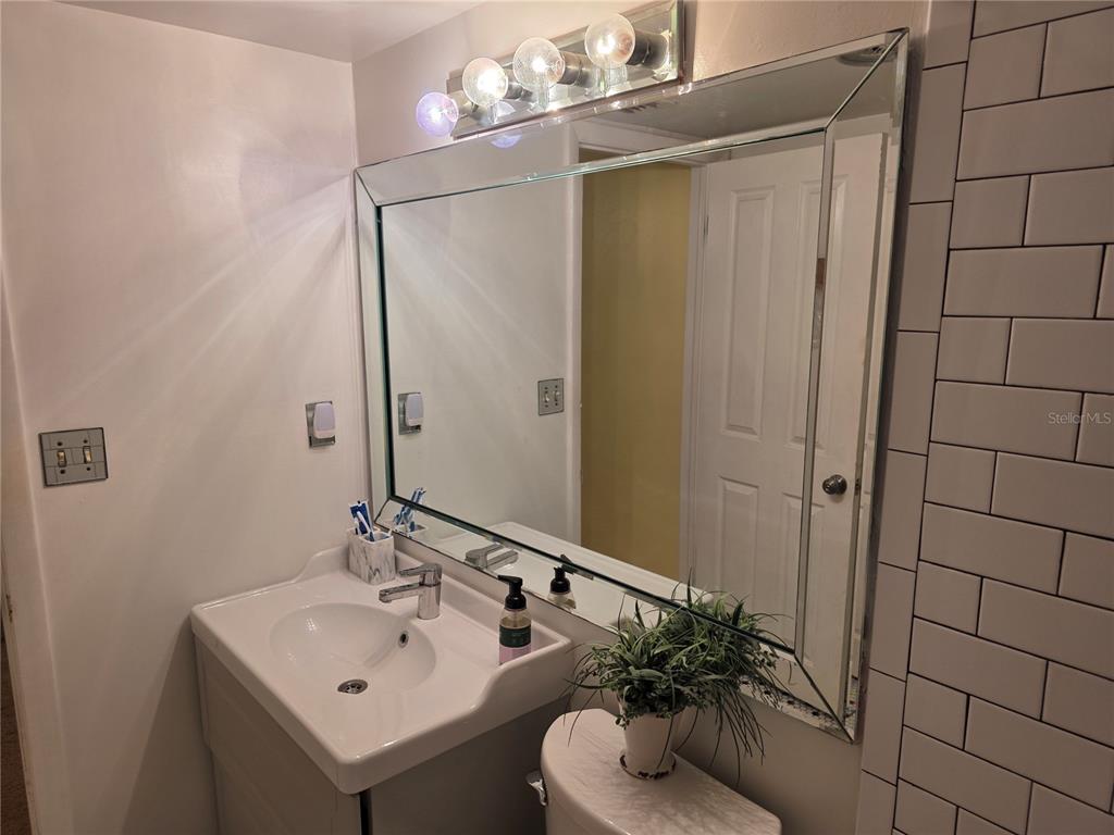 17580 Gulf Boulevard, Unit 311 Redington Shores, FL 33708 - Photo 25 of 34 a bathroom with a sink toilet and shower