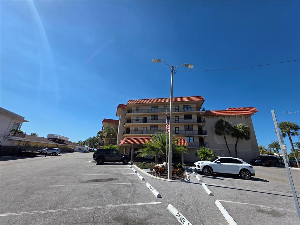 17580 Gulf Boulevard, Unit 311 Redington Shores, FL 33708 - Photo 32 of 34 a view of a cars parked in front of a building