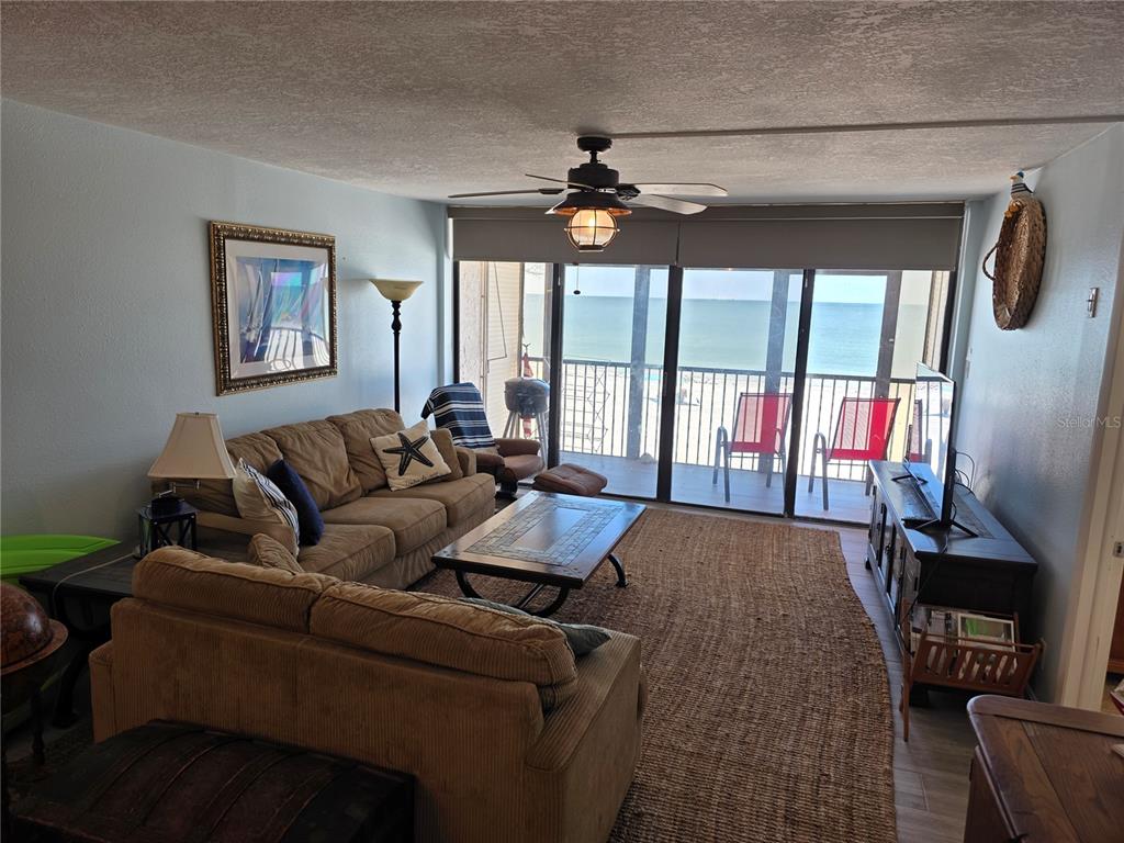 17580 Gulf Boulevard, Unit 311 Redington Shores, FL 33708 - Photo 5 of 34 a living room with furniture fireplace and a flat screen tv
