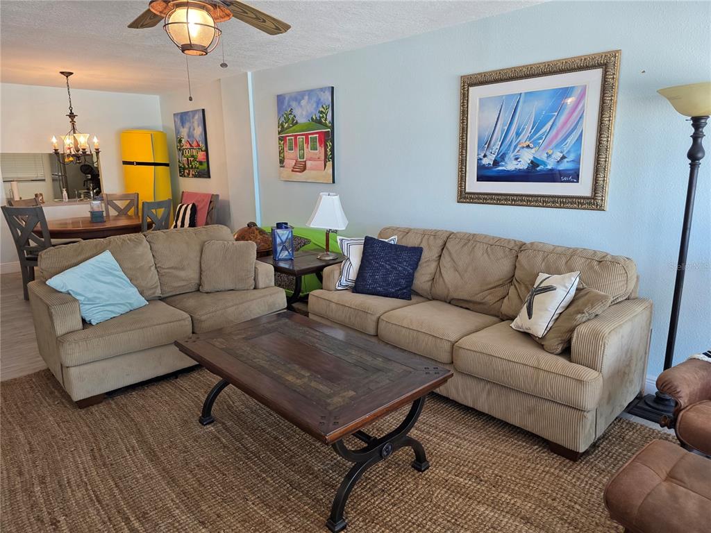 17580 Gulf Boulevard, Unit 311 Redington Shores, FL 33708 - Photo 6 of 34 a living room with furniture and wooden floor