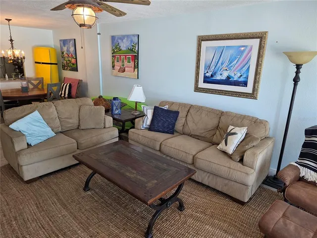 a living room with furniture a rug and a window