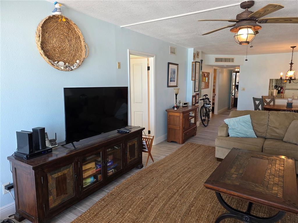 17580 Gulf Boulevard, Unit 311 Redington Shores, FL 33708 - Photo 9 of 34 a living room with furniture and a flat screen tv