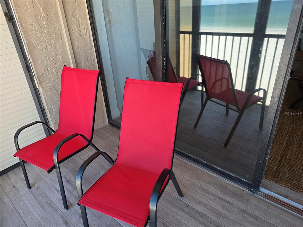 17580 Gulf Boulevard, Unit 311 Redington Shores, FL 33708 - Photo 10 of 34 a view of a room with chairs and wooden floor