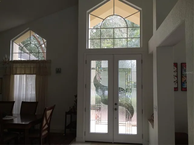 a living room with furniture and a mirror
