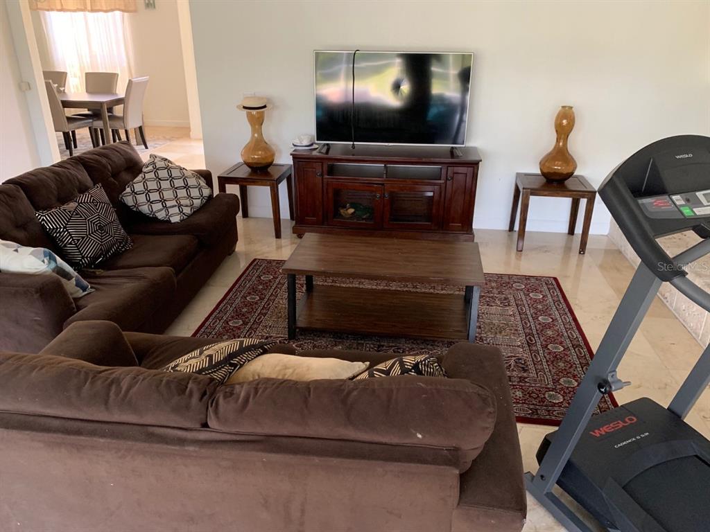 8125 Courtleigh Drive Orlando, FL 32835 - Photo 15 of 26 a living room with furniture and a flat screen tv