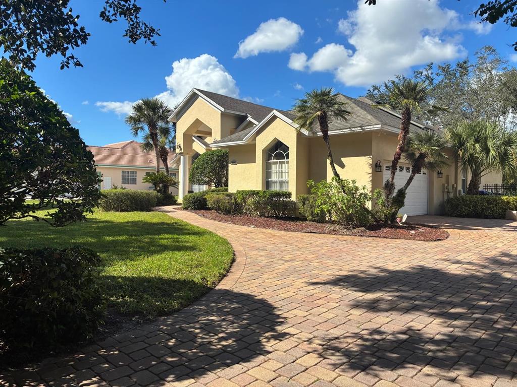 8125 Courtleigh Drive Orlando, FL 32835 - Photo 2 of 26 a front view of a house with a yard and garage