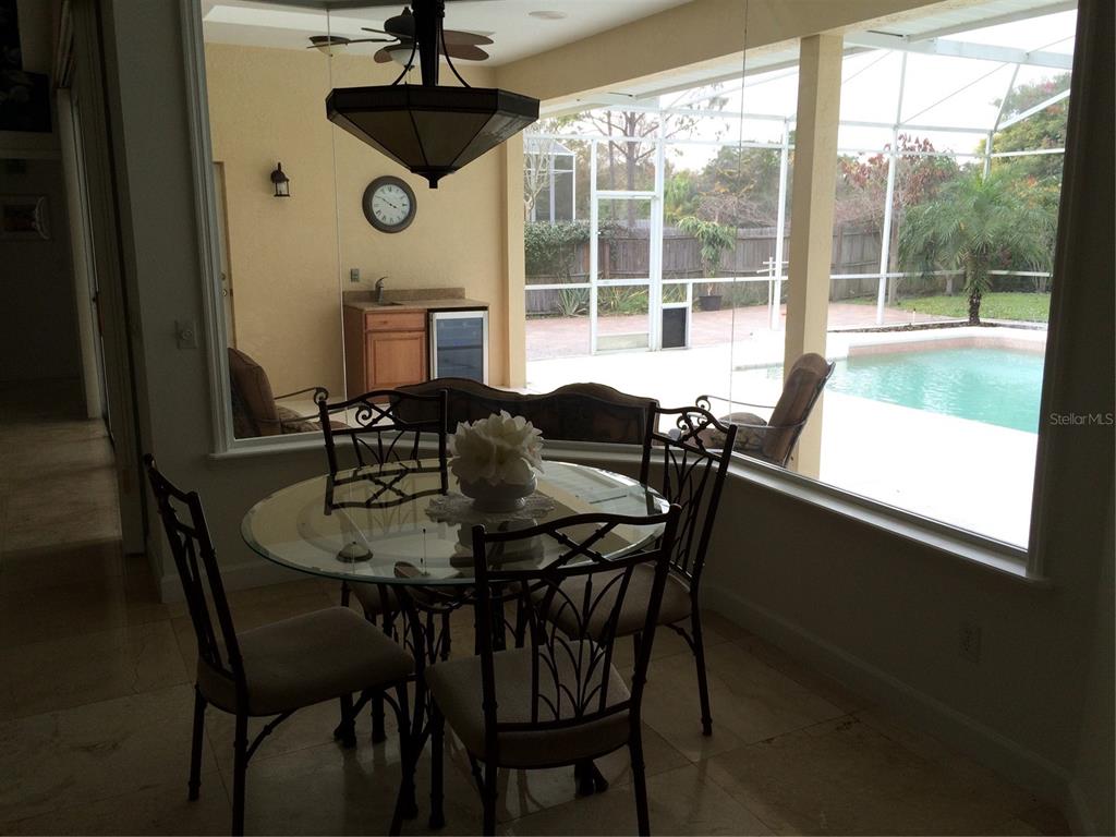 8125 Courtleigh Drive Orlando, FL 32835 - Photo 22 of 26 a dining room with furniture and window