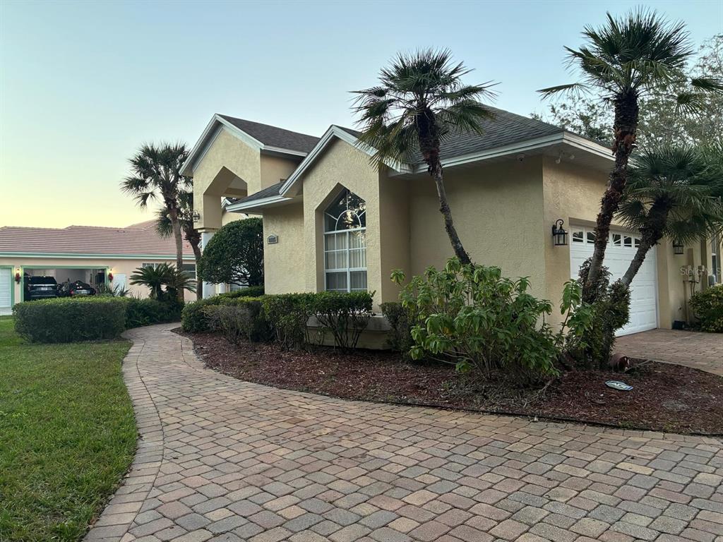 8125 Courtleigh Drive Orlando, FL 32835 - Photo 3 of 26 a front view of a house with a garden