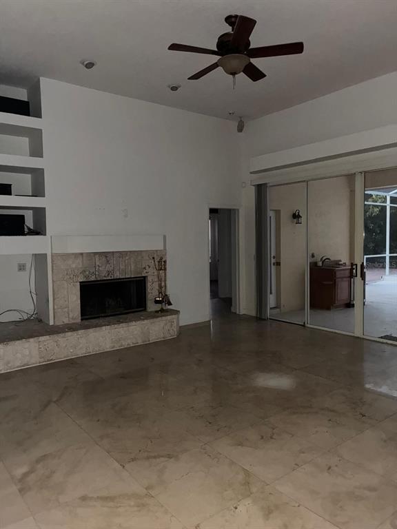 8125 Courtleigh Drive Orlando, FL 32835 - Photo 10 of 26 a view of empty room with fireplace and fan