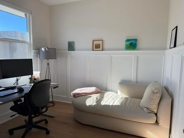 a living room with furniture and a chair