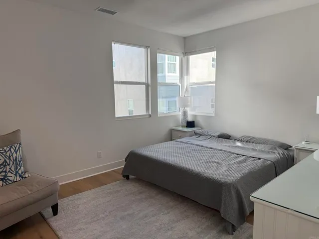 a bed sitting in a bedroom next to a window