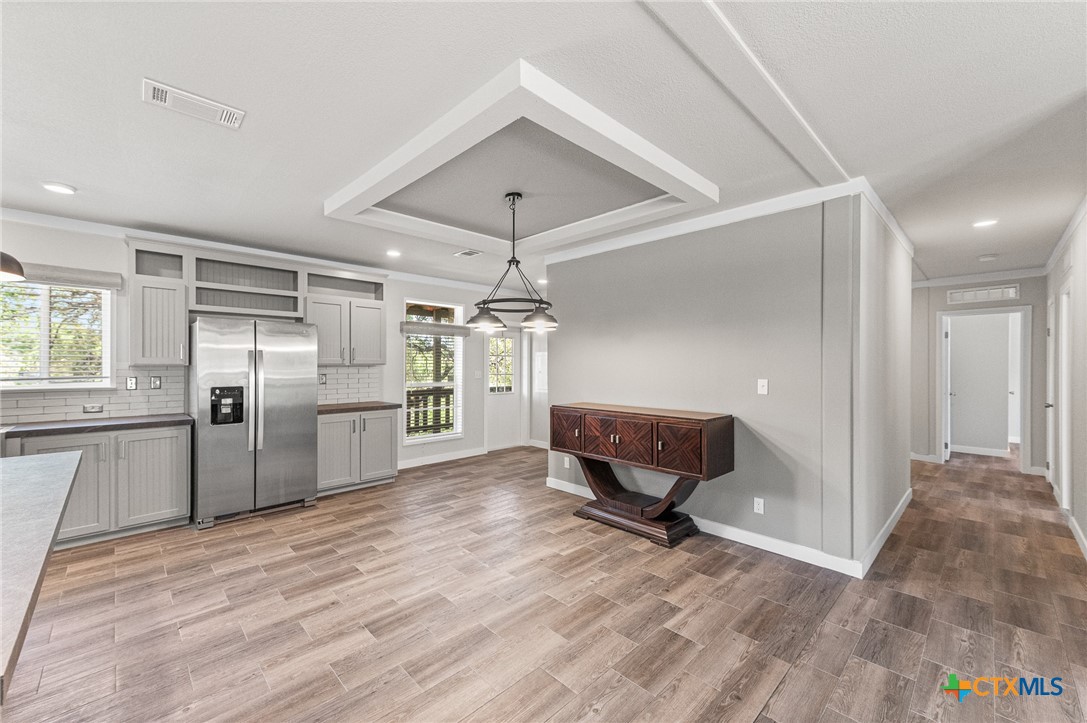 9130 Rebecca Creek Road Spring Branch, TX 78070 - Photo 12 of 41 a view of a kitchen with wooden floor and a refrigerator