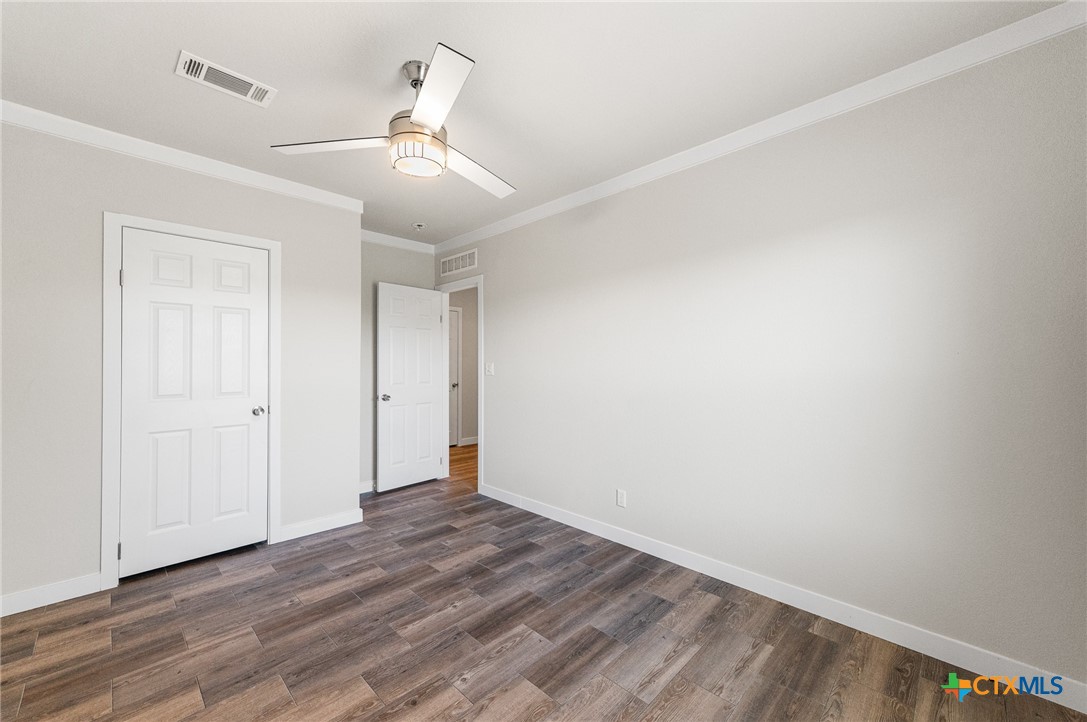 9130 Rebecca Creek Road Spring Branch, TX 78070 - Photo 21 of 41 wooden floor in an empty room