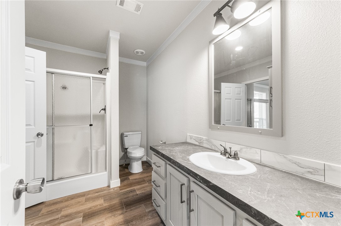9130 Rebecca Creek Road Spring Branch, TX 78070 - Photo 22 of 41 a bathroom with a granite countertop sink and a mirror