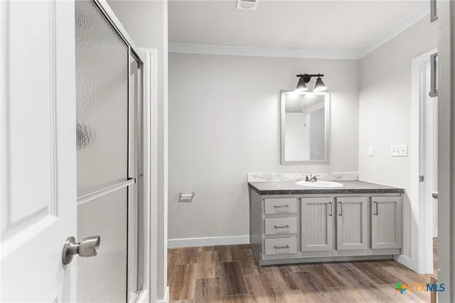 a view of bathroom with a sink and mirror