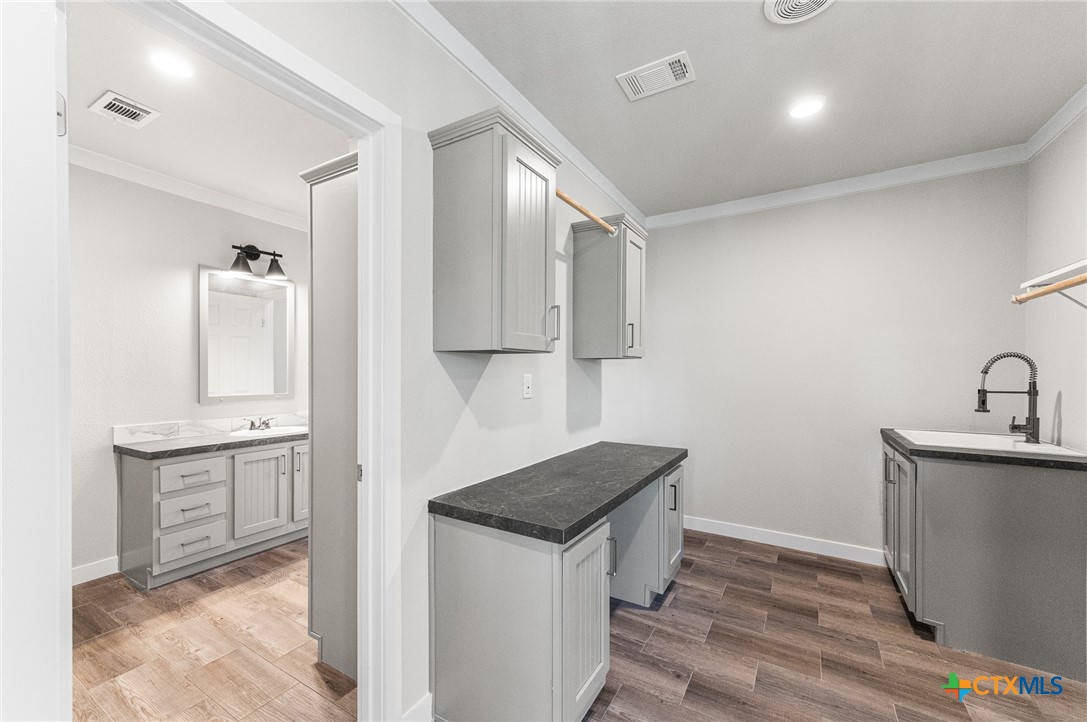 9130 Rebecca Creek Road Spring Branch, TX 78070 - Photo 24 of 41 a kitchen with stainless steel appliances granite countertop a sink stove and refrigerator