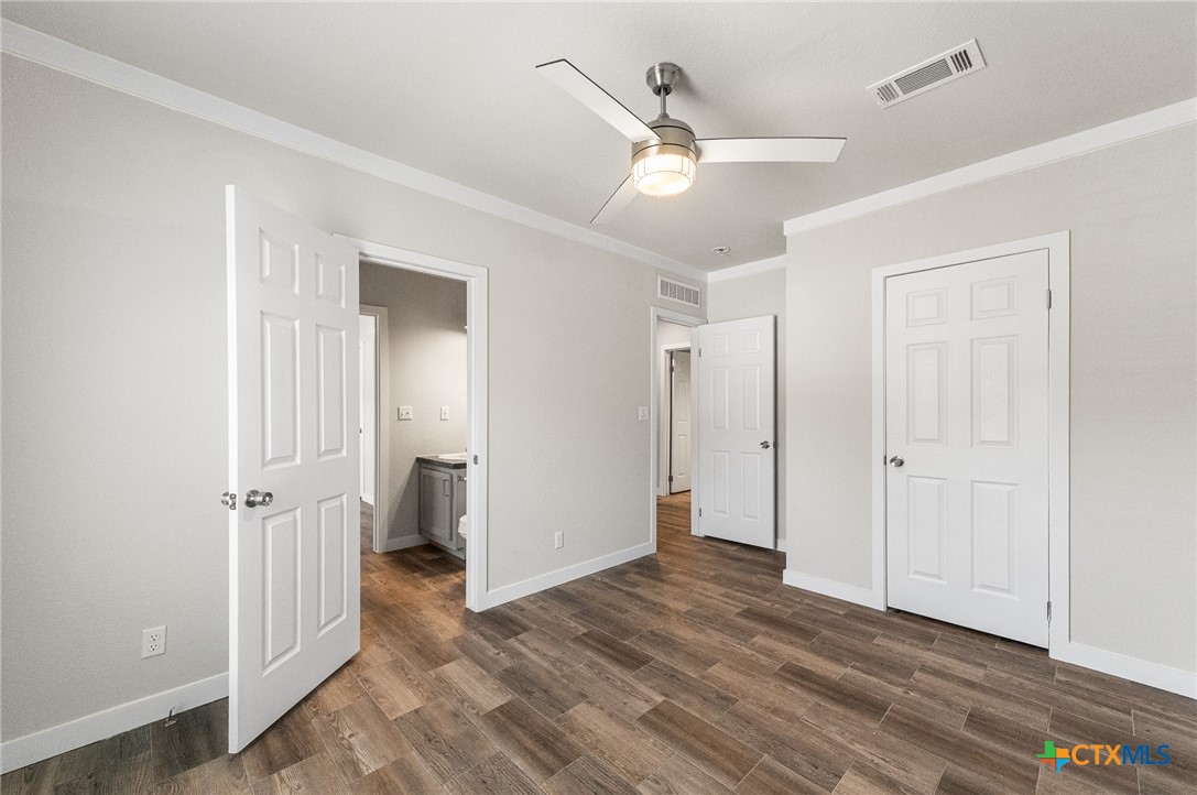 9130 Rebecca Creek Road Spring Branch, TX 78070 - Photo 26 of 41 an empty room with wooden floor and closet