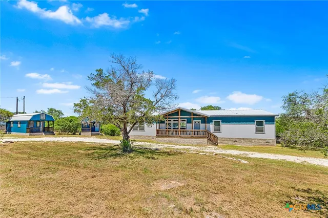 a swimming pool with outdoor seating and yard