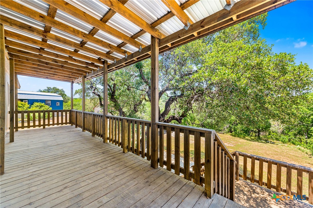 9130 Rebecca Creek Road Spring Branch, TX 78070 - Photo 31 of 41 a view of a balcony with wooden floor