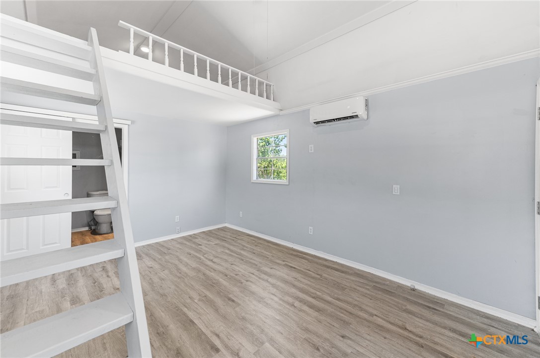 9130 Rebecca Creek Road Spring Branch, TX 78070 - Photo 34 of 41 a view of an empty room with closet and wooden floor