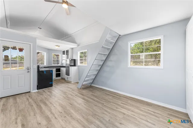 a view of a room with wooden floor windows and entryway