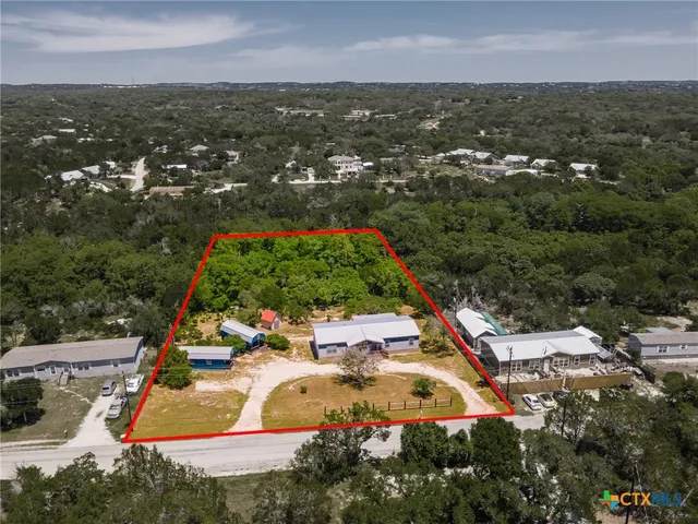 an aerial view of residential houses with outdoor space