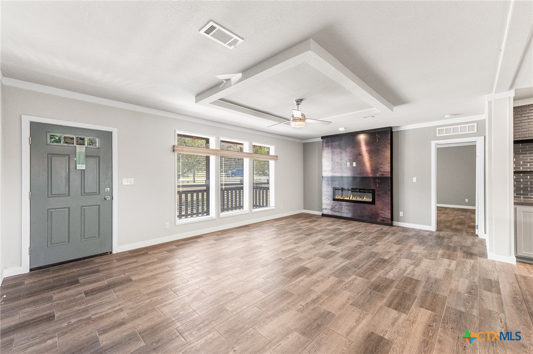 9130 Rebecca Creek Road Spring Branch, TX 78070 - Photo 4 of 41 a view of an empty room with a window and wooden floor