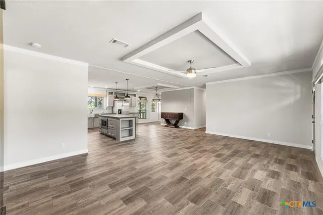 a view of kitchen and hall with wooden floor