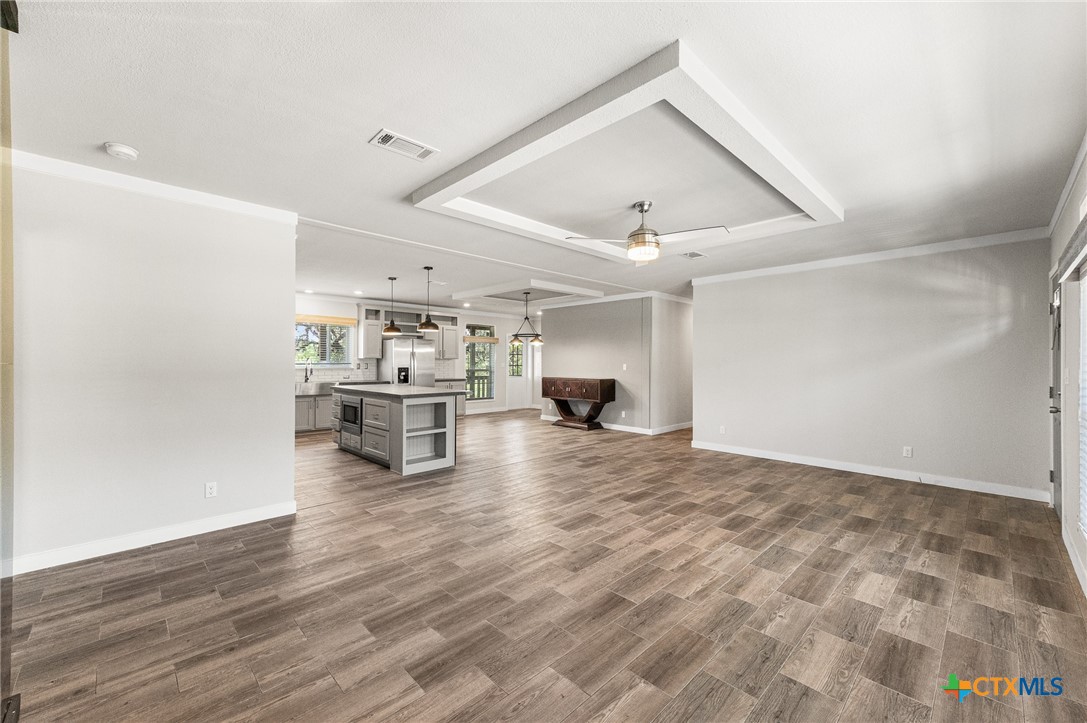 9130 Rebecca Creek Road Spring Branch, TX 78070 - Photo 6 of 41 a view of kitchen and hall with wooden floor
