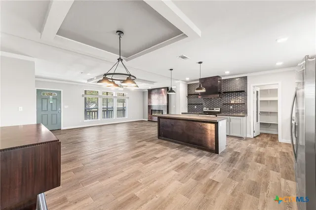 a view of kitchen with sink microwave and refrigerator