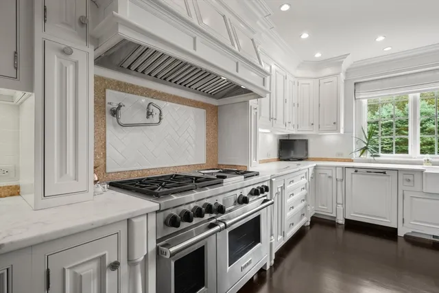 a kitchen with granite countertop a stove sink and cabinets