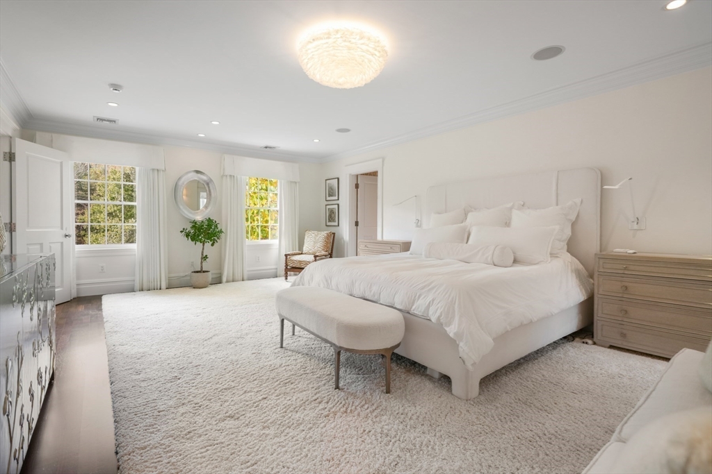 8 Hamlins Crossing East Dover, MA 02030 - Photo 26 of 42 a spacious bedroom with a large bed and a chandelier