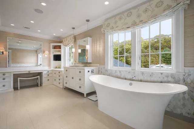 a spacious bathroom with a large tub sink and mirror