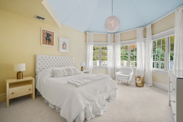 a bedroom with a bed a table and chair