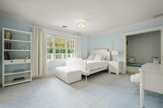 a bed room with a bed and a chair