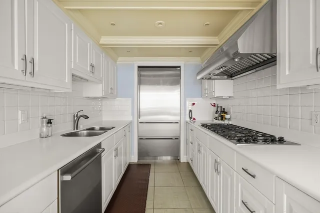 a kitchen with stainless steel appliances a sink dishwasher stove and refrigerator