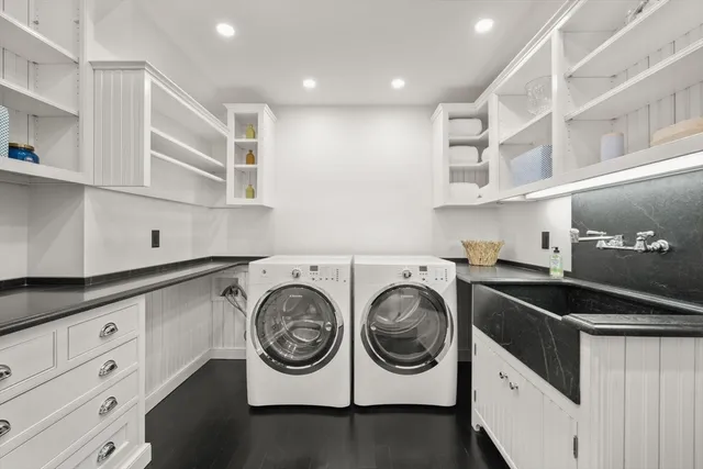 a utility room with cabinets and washer