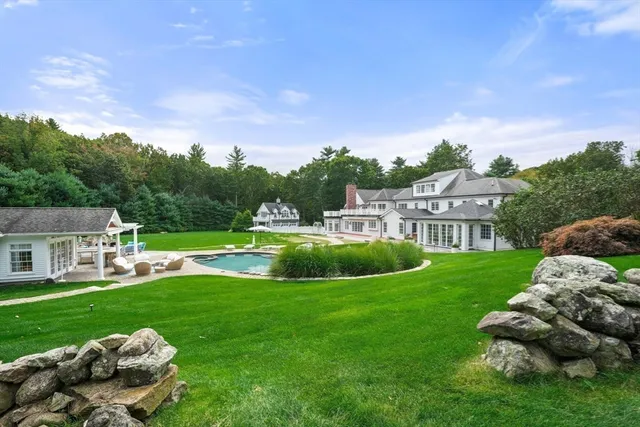 a view of a house with a backyard and a garden