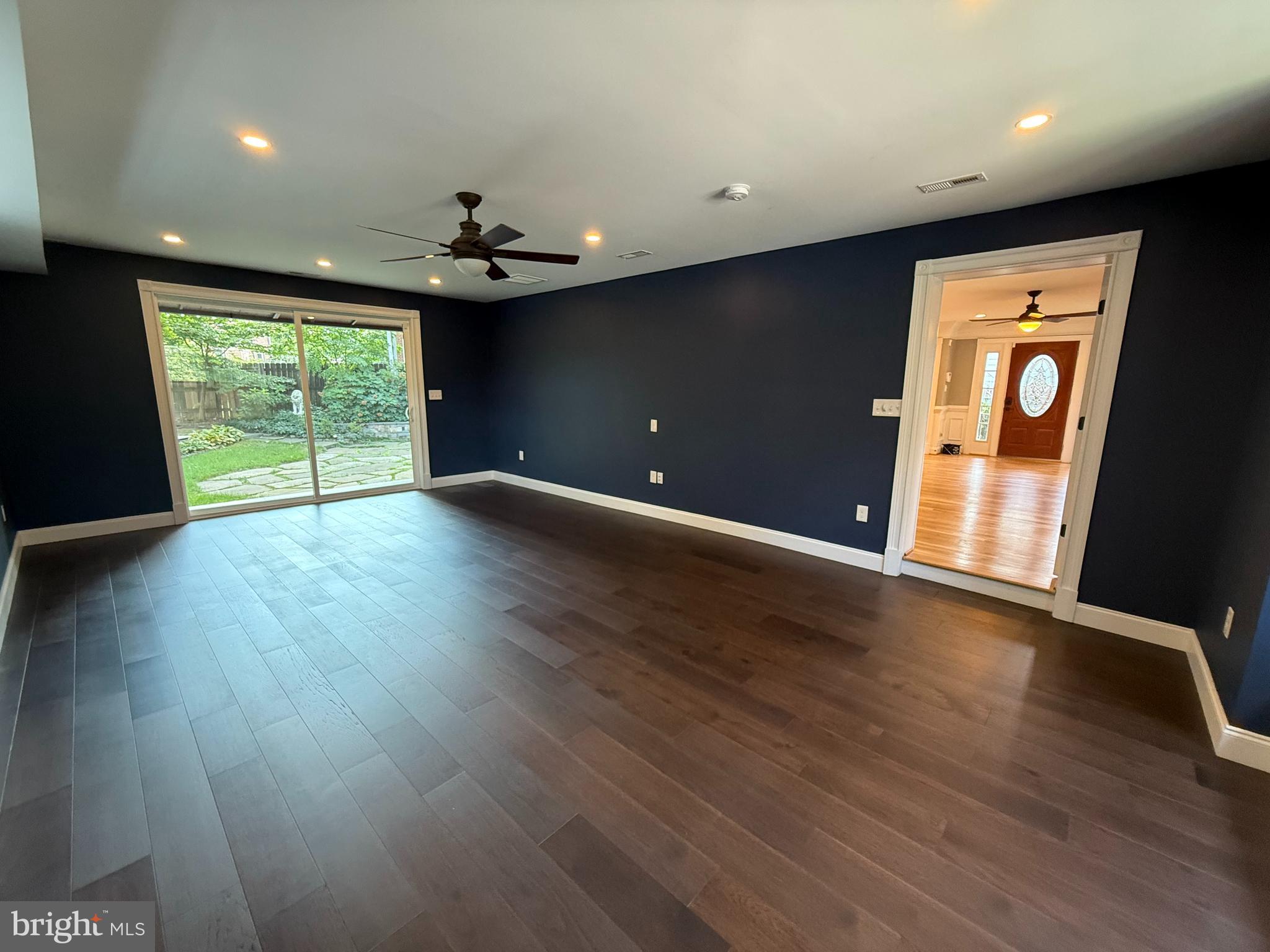 8103 Piney Branch Road Silver Spring, MD 20910 - Photo 9 of 42 an empty room with wooden floor chandelier and windows