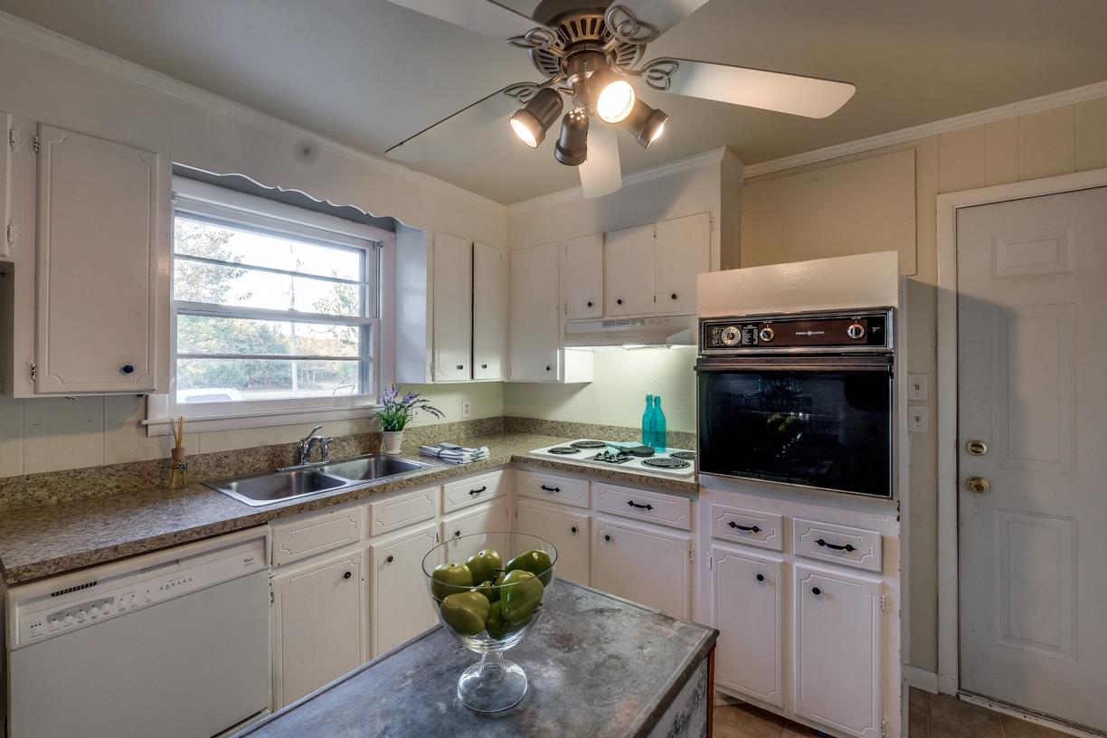 1808 Hygeia Road Greenbrier, TN 37073 - Photo 4 of 12 a kitchen with stainless steel appliances white cabinets a stove a sink and a bathtub