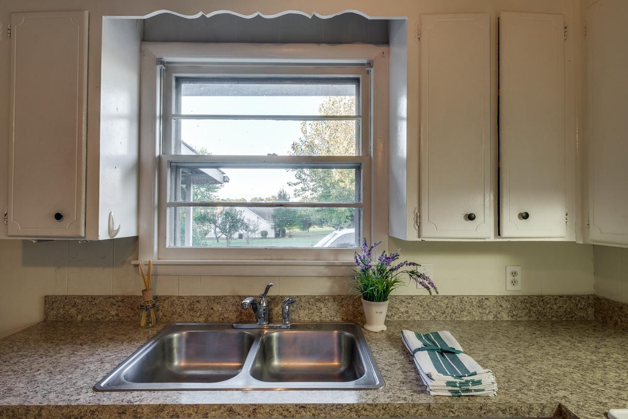 1808 Hygeia Road Greenbrier, TN 37073 - Photo 5 of 12 a kitchen with granite countertop a sink a granite counter tops and a wooden floor