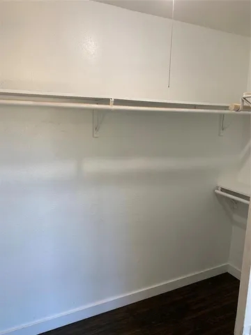 a view of a closet with wooden floor