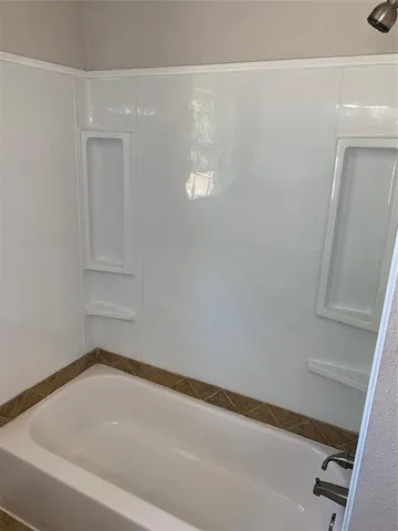 a bathroom with a window and a shower