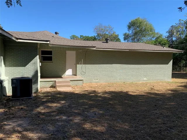 a view of backyard of house with green space