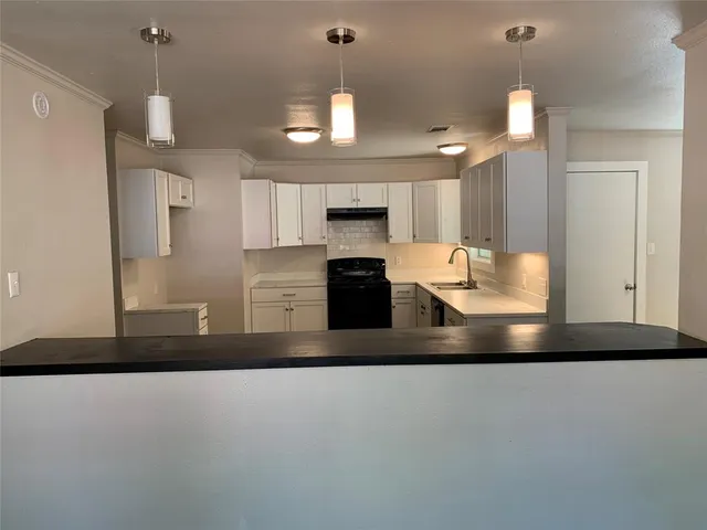a view of kitchen with refrigerator and window