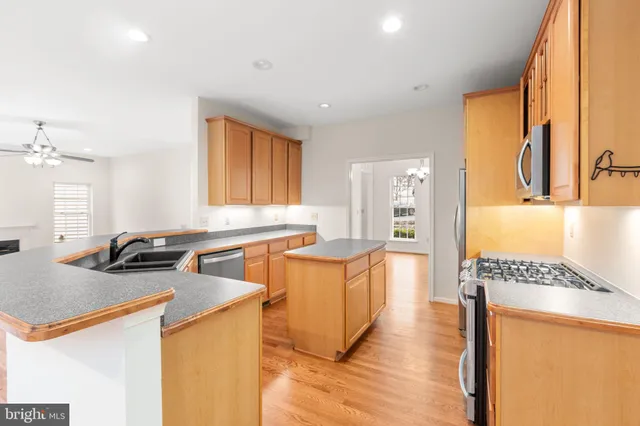a view of empty room with wooden floor and fireplace