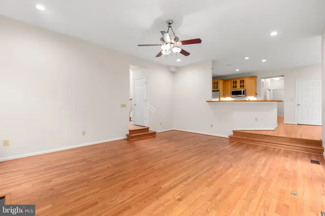 a view of staircase with wooden floor and a window